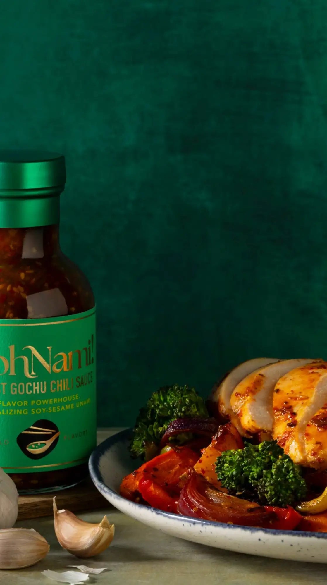 A vibrant green-labeled bottle of gochu chil sauce with a matching metallic cap, showcasing its rich red contents and bold branding.
